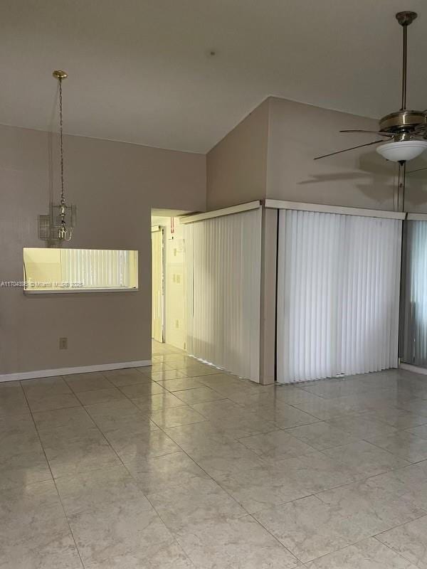 unfurnished room with ceiling fan and lofted ceiling