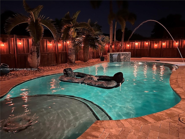 pool at twilight with pool water feature