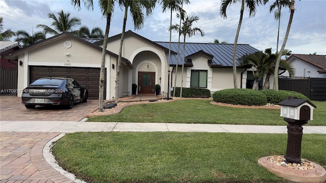 single story home with a front yard and a garage