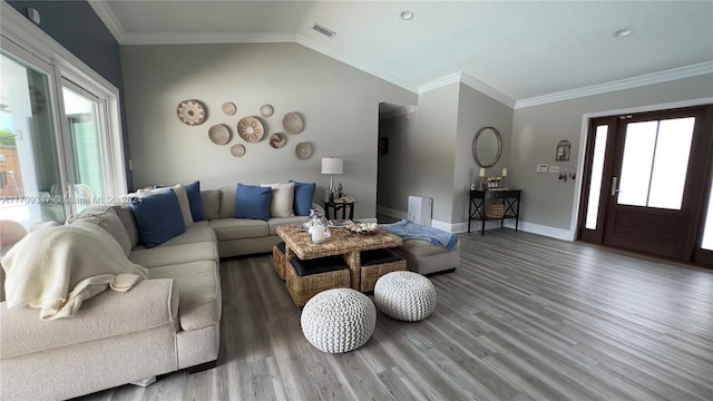 living room with hardwood / wood-style floors, a healthy amount of sunlight, and vaulted ceiling