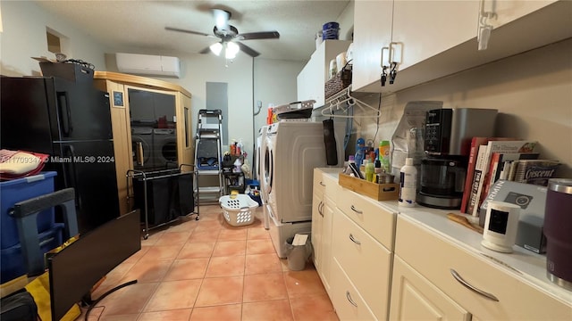 kitchen with ceiling fan, washing machine and dryer, black fridge, an AC wall unit, and white cabinets