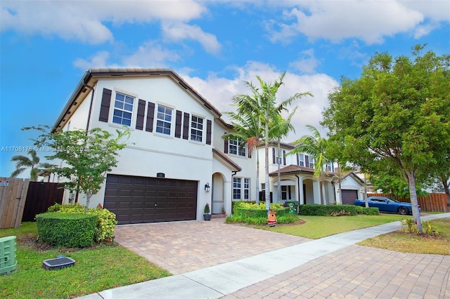 view of front of home featuring a garage and a front lawn