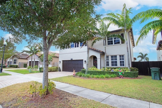 mediterranean / spanish-style home with a front yard and a garage