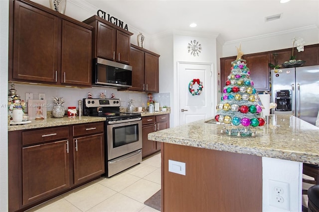 kitchen featuring a center island, ornamental molding, and appliances with stainless steel finishes