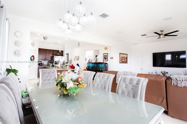 dining space with crown molding and ceiling fan