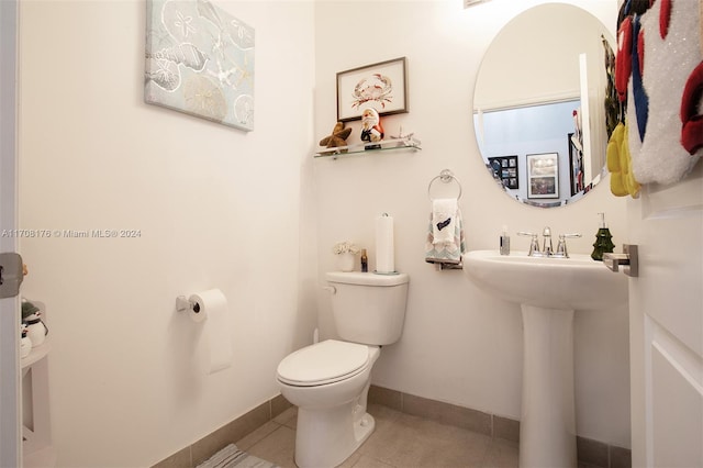 bathroom with tile patterned floors, toilet, and sink