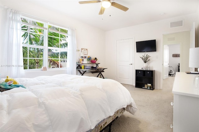 bedroom with ceiling fan and light colored carpet