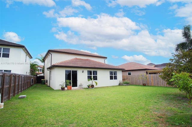 back of property featuring a yard