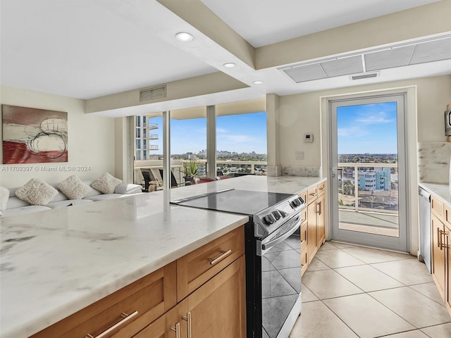 kitchen with light tile patterned floors and stainless steel appliances