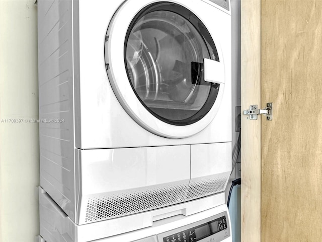 laundry room with stacked washer / drying machine