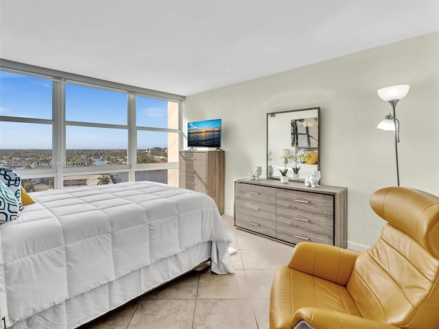 bedroom featuring light tile patterned floors and floor to ceiling windows