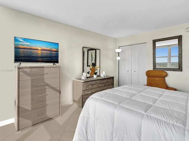 tiled bedroom featuring a closet