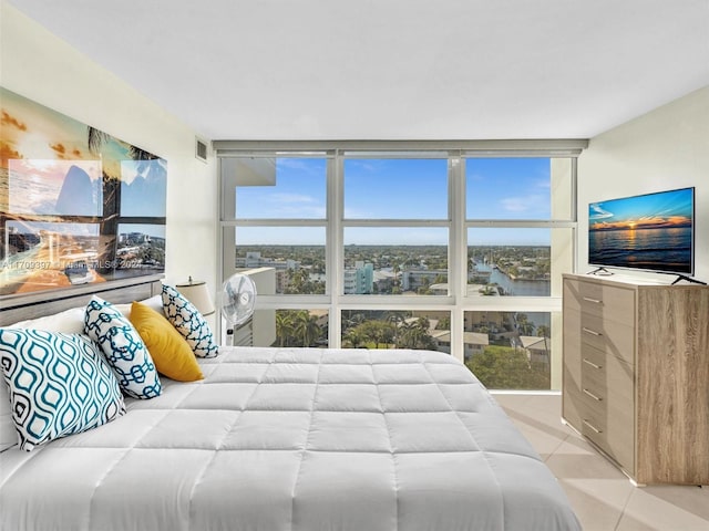 bedroom with light tile patterned flooring and floor to ceiling windows