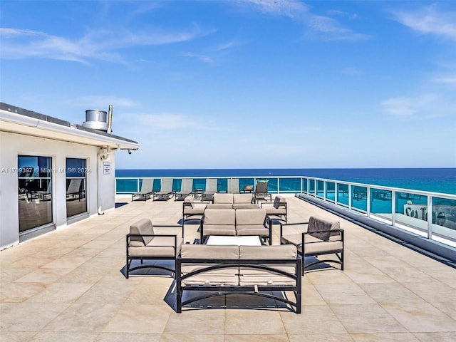 view of patio featuring a water view and a balcony