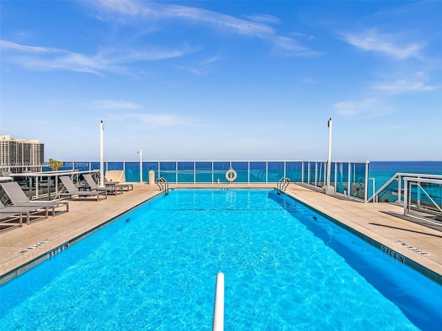 view of pool with a water view