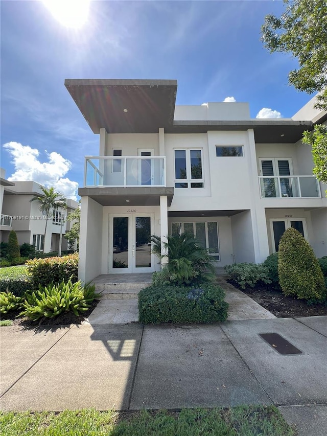 view of front of property with french doors and a balcony