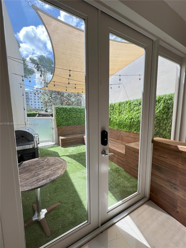 doorway featuring tile patterned flooring and a wealth of natural light