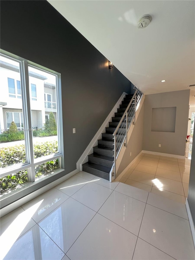 stairs featuring tile patterned floors