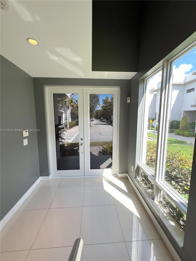 unfurnished sunroom with french doors