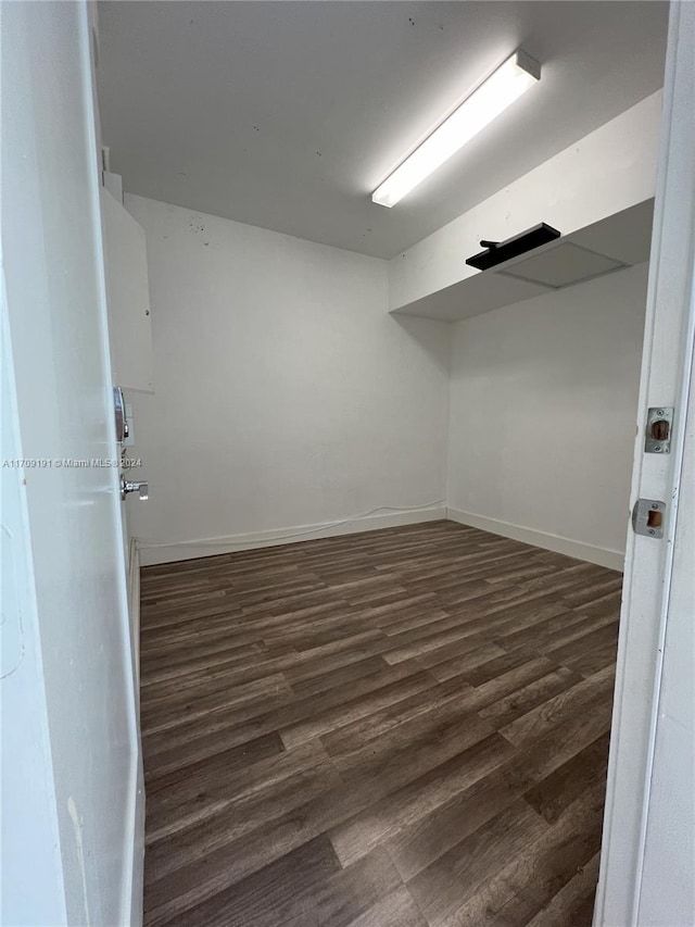 spare room featuring dark wood-type flooring