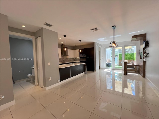 kitchen featuring french doors, wall chimney exhaust hood, light tile patterned floors, decorative backsplash, and white cabinets