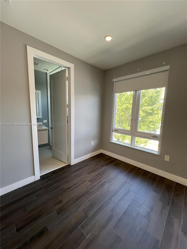 unfurnished room featuring dark hardwood / wood-style flooring