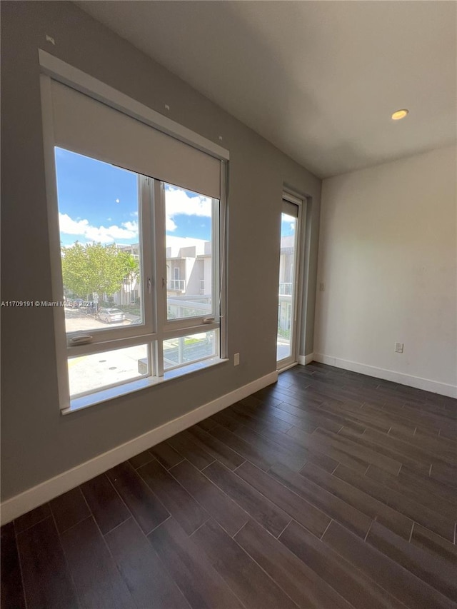 empty room with dark hardwood / wood-style floors