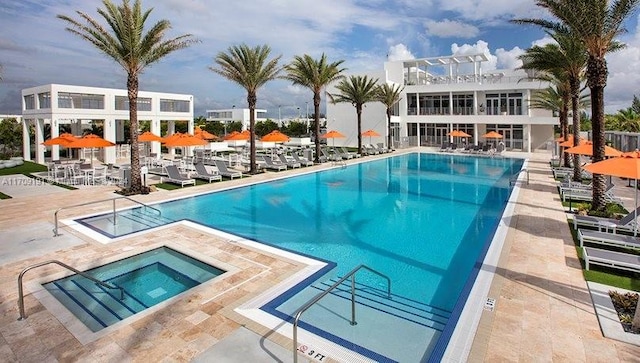 view of pool featuring a community hot tub and a patio