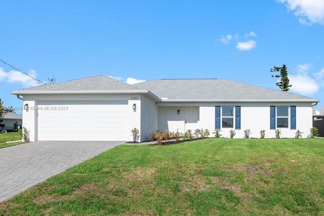 ranch-style house featuring a front lawn and a garage