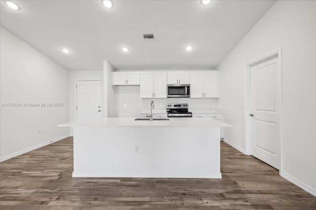 kitchen with dark hardwood / wood-style flooring, white cabinetry, stainless steel appliances, and an island with sink