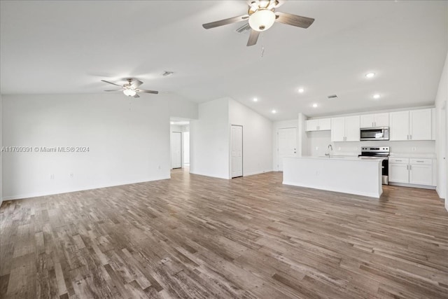 unfurnished living room with ceiling fan, vaulted ceiling, and hardwood / wood-style flooring