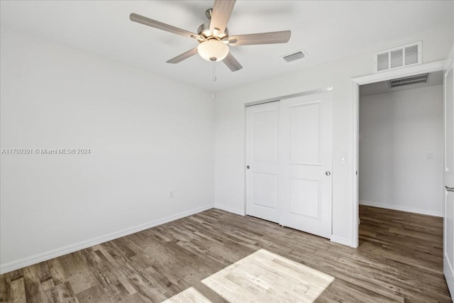 unfurnished bedroom featuring a closet, ceiling fan, and hardwood / wood-style flooring