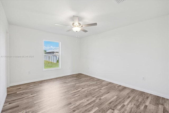 unfurnished room featuring hardwood / wood-style floors and ceiling fan