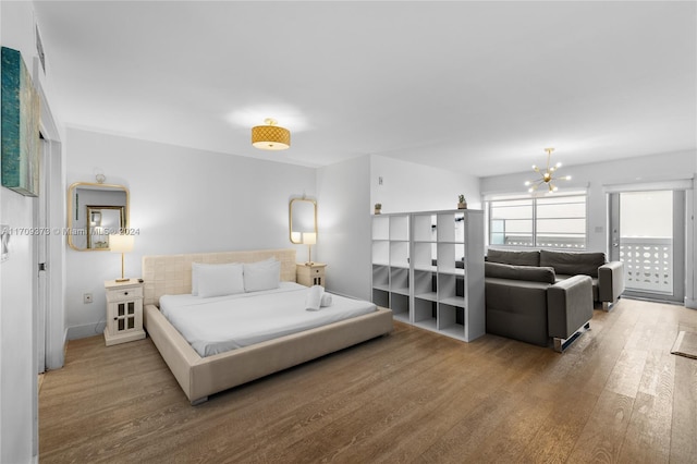 bedroom with a chandelier and hardwood / wood-style floors