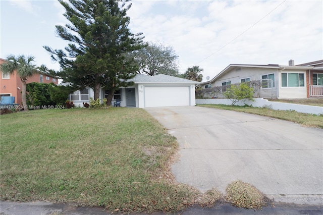 ranch-style house featuring a garage and a front lawn