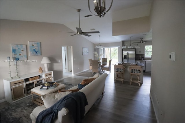 living room with dark wood-type flooring and vaulted ceiling