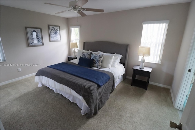 bedroom with light carpet and ceiling fan