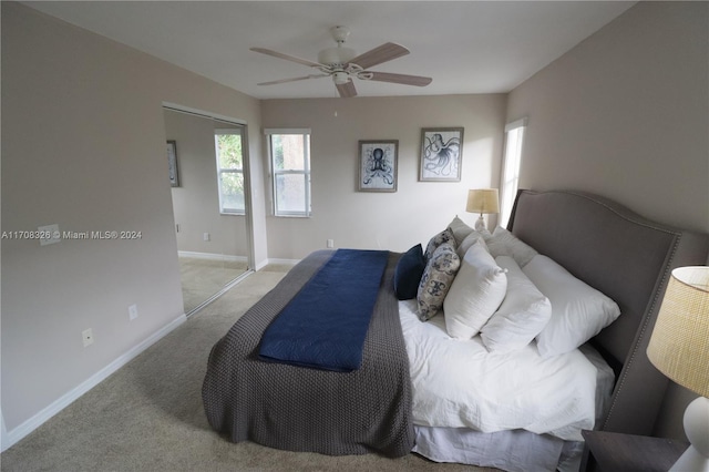 bedroom featuring ceiling fan, light colored carpet, and a closet