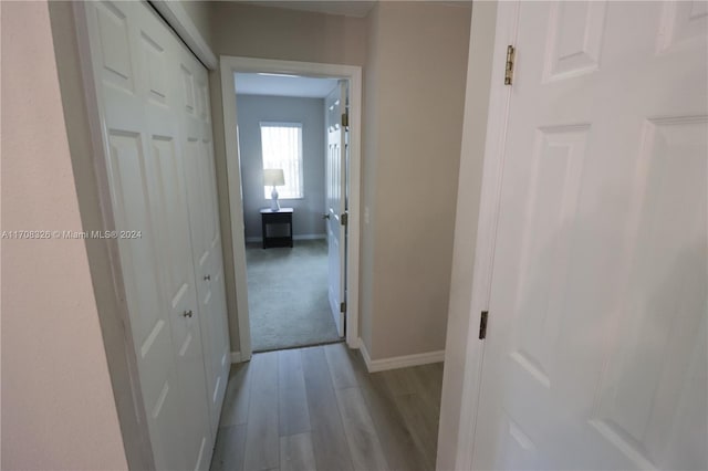 corridor with light hardwood / wood-style floors