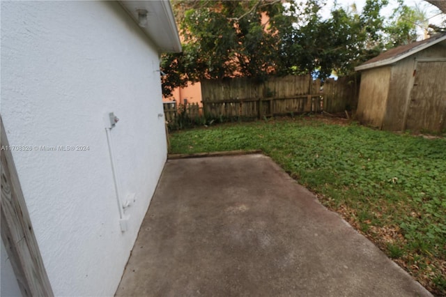 view of yard with a patio and a storage shed