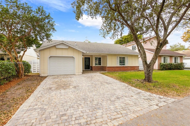 view of front of home with a garage and a front lawn