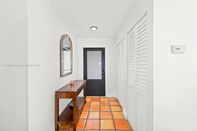 doorway to outside with light tile patterned floors