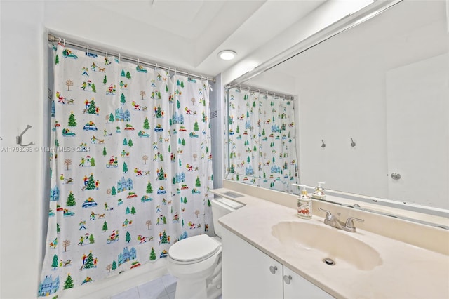 bathroom with toilet, vanity, and tile patterned floors