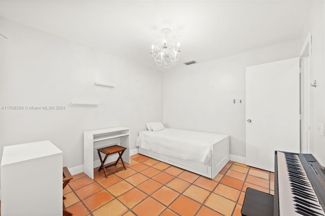 tiled bedroom featuring a notable chandelier