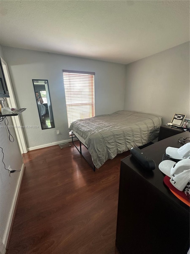 bedroom featuring dark hardwood / wood-style flooring