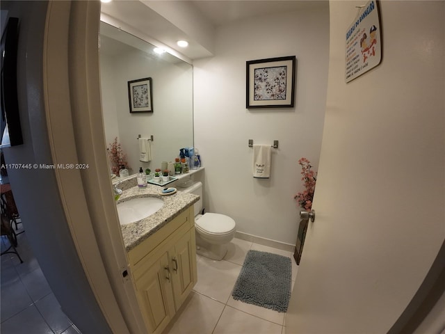 bathroom featuring tile patterned flooring, vanity, and toilet