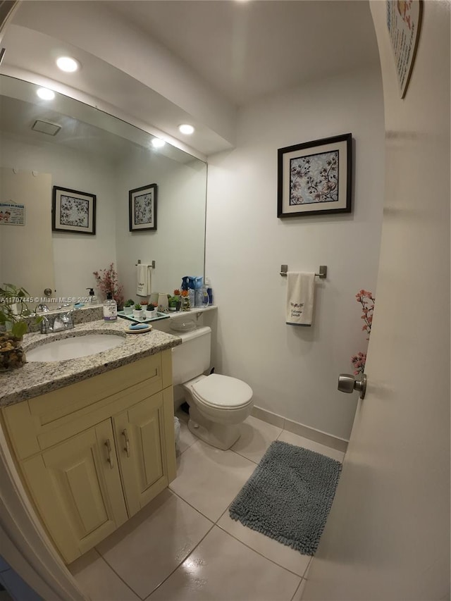 bathroom featuring toilet, vanity, and tile patterned floors