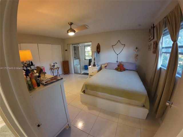 bedroom with light tile patterned flooring, a closet, multiple windows, and ceiling fan