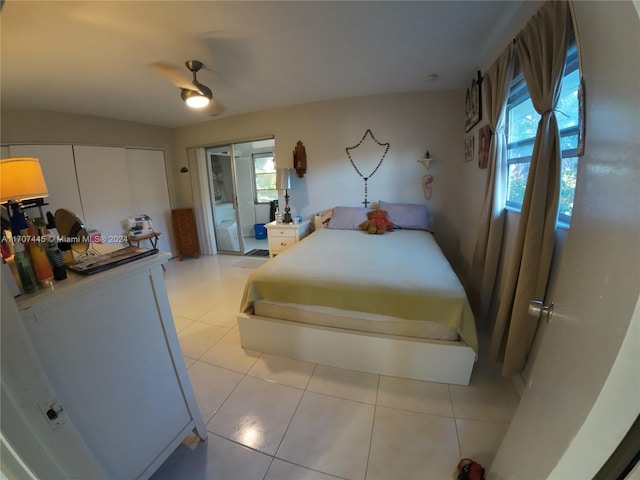 bedroom with light tile patterned flooring, multiple windows, and ceiling fan