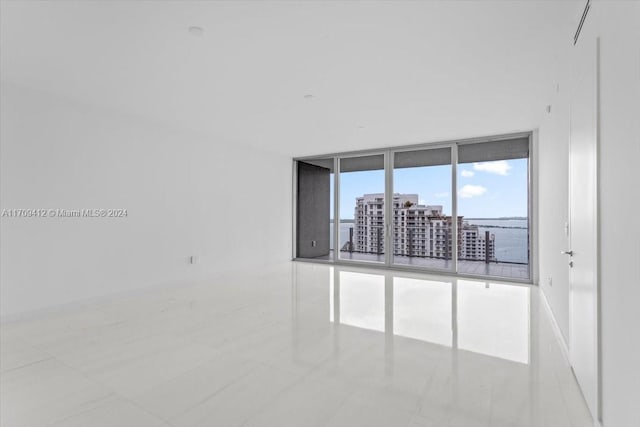 unfurnished room with floor to ceiling windows